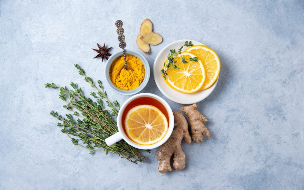 Creative flat lay with ingredients to boost immunity. Ingredients ginger, thyme, turmeric and lemon
